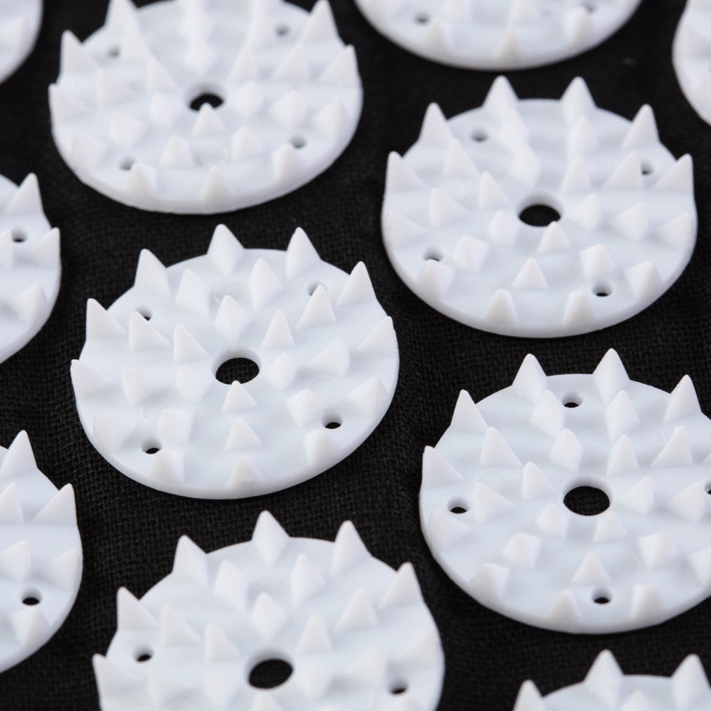 White circular objects with spike-like protrusions on a black background