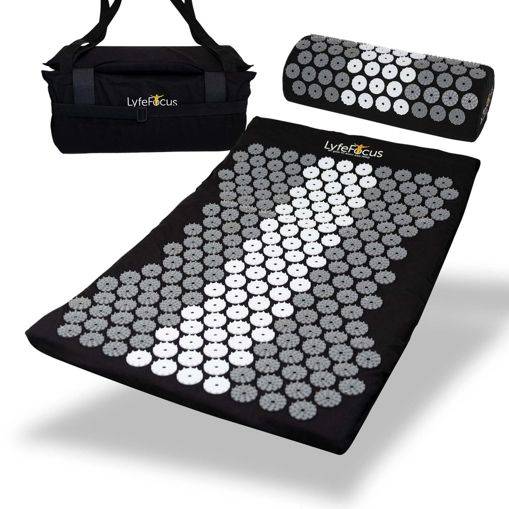 Acupressure mat and pillow set with carrying bag on a white background, branded 'Lyfe Focus'.