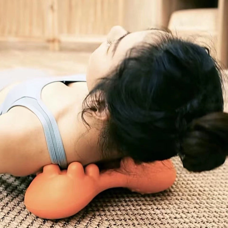 Person using an orange neck pillow on a couch