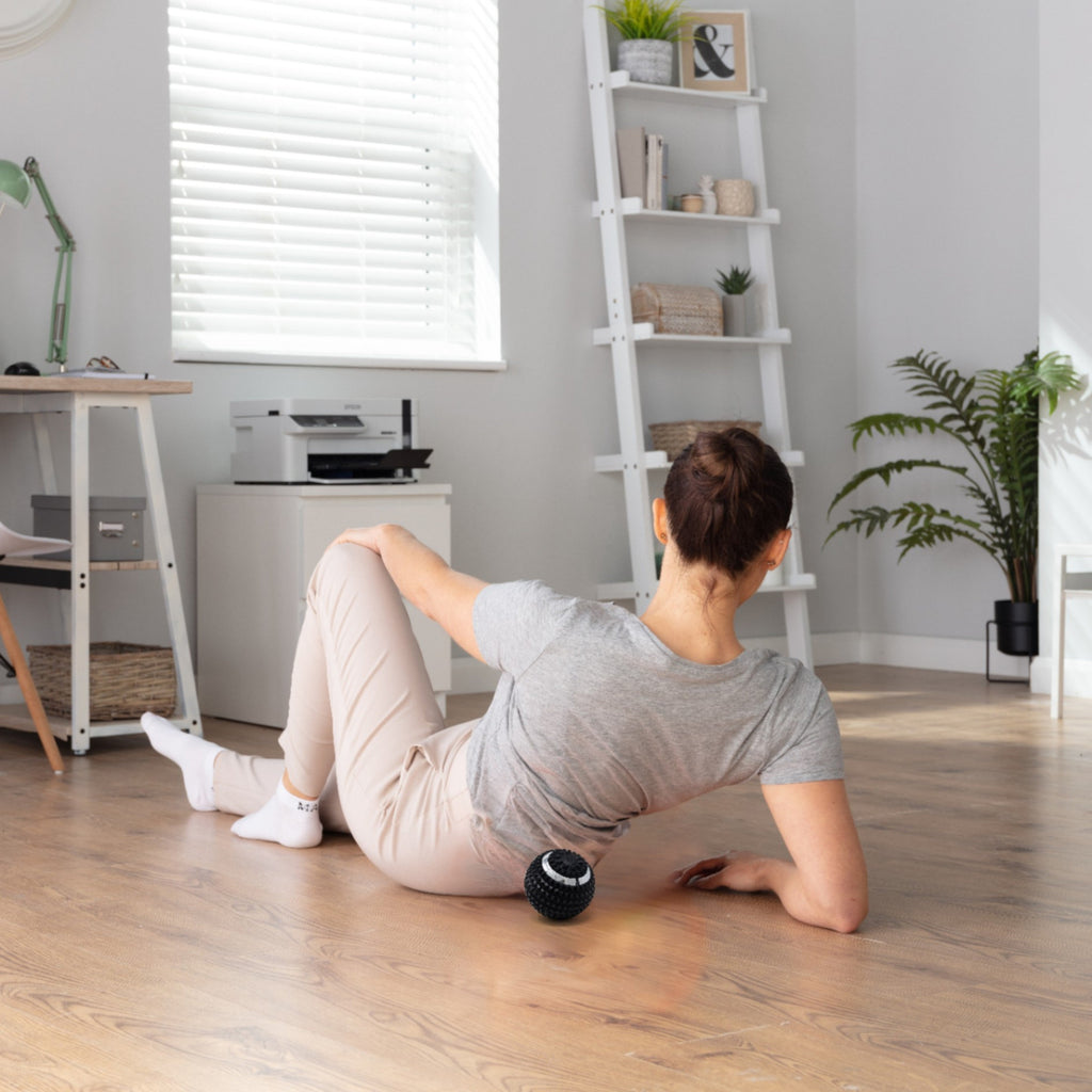 Woman exercising with a medicine ball in a home office setting