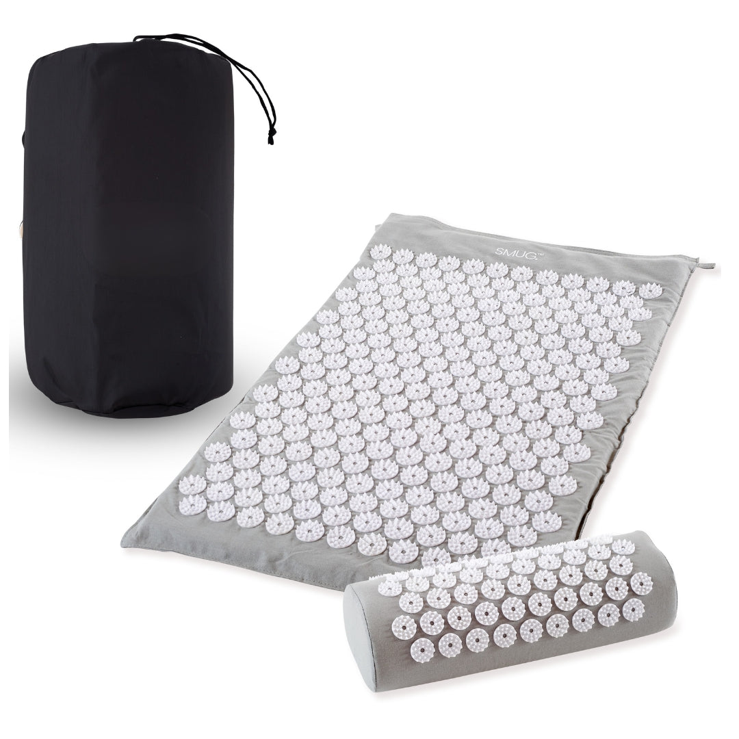 Acupressure mat with roller and black carrying bag on a white background